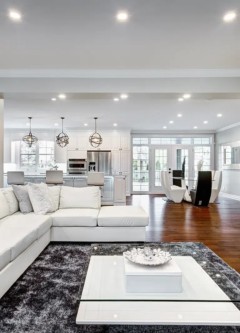 Painting-Services-On-The-Central-Coast-NSW-PTM-1.webp A large living room with white walls, by Coast of Paint, providing Painting Services on the Central Coast NSW