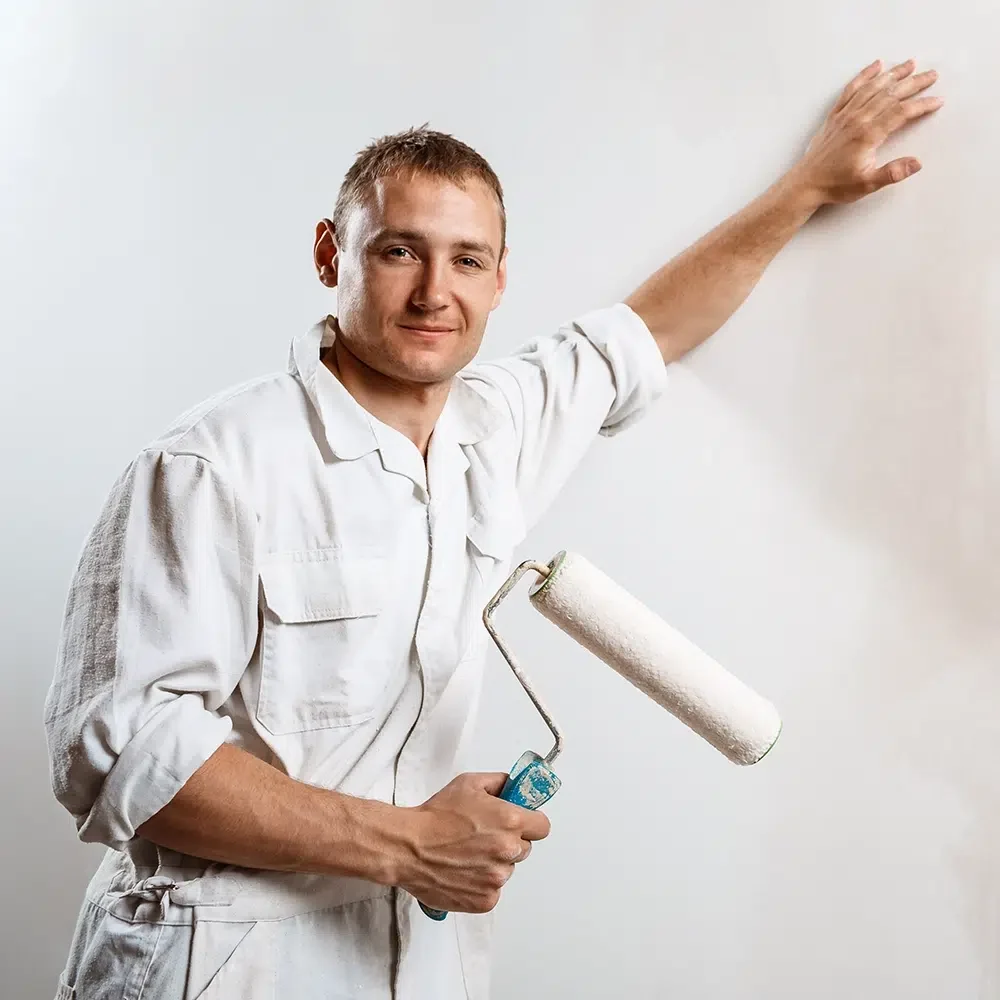 worker-looking-camera-holding-roller copy Chat with an Expert, Qualified Painter on the Central Coast NSW